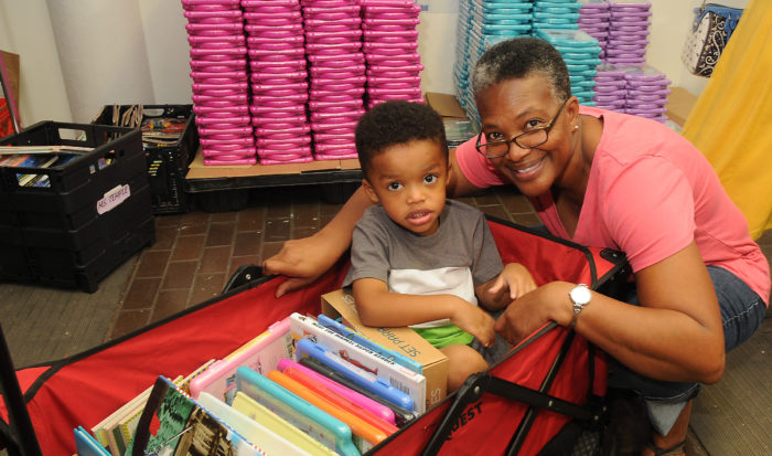A teacher and her grandson at a Houston book distribution supported in part by Penguin Random House post-Hurricane Harvey