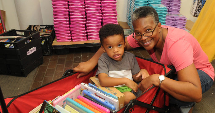 adult with a child at a book distribution event
