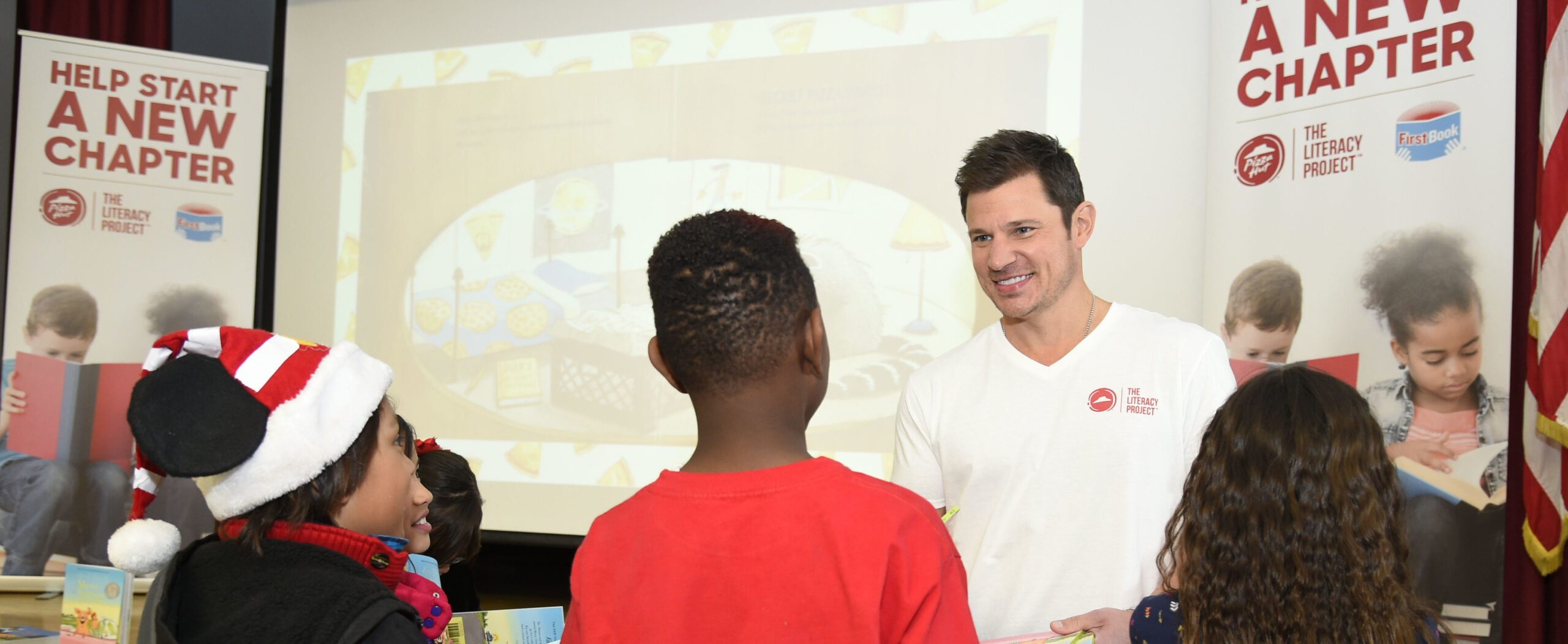 Nick Lachey, First Book, and Pizza Hut surprise elementary students with a pizza party.