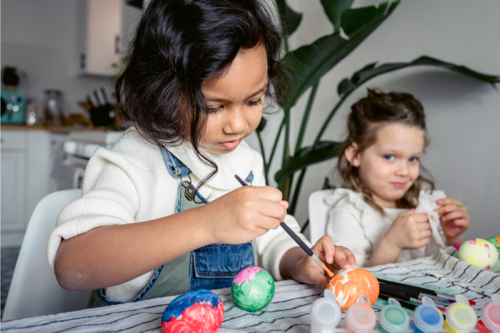 Children painting holiday eggs