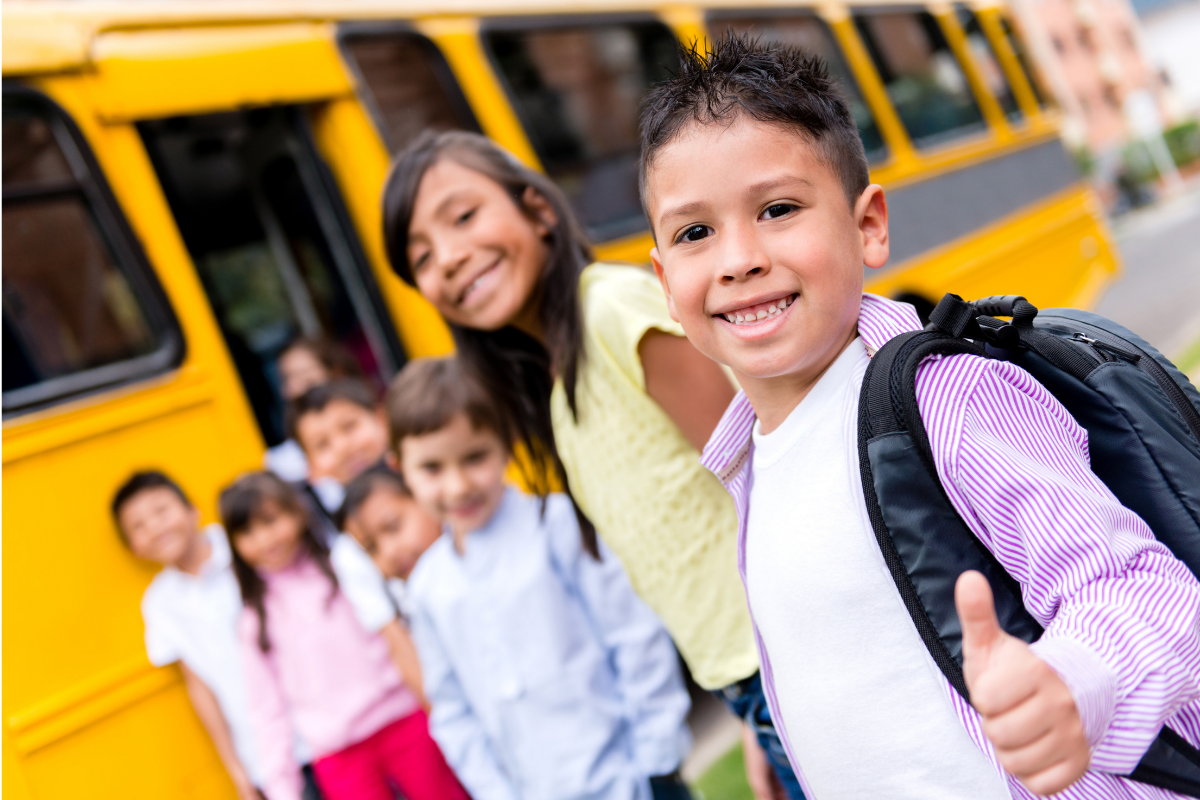 hispanic heritage month, kids in front of a school bus