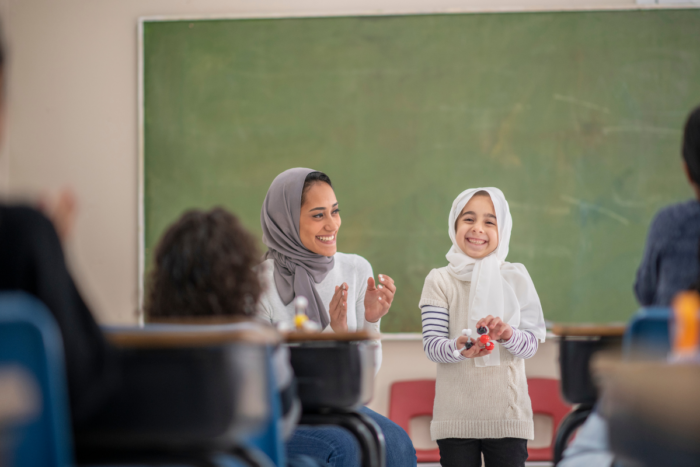 muslim teacher and student in a classroom