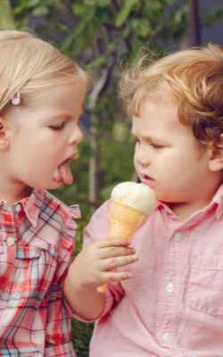 two kids refusing to share ice cream
