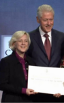 kyle zimmer with bill clinton accepting an award