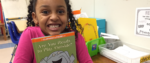 excited girl hugging elephant and piggie books