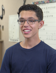 teen boy smiling in classoom