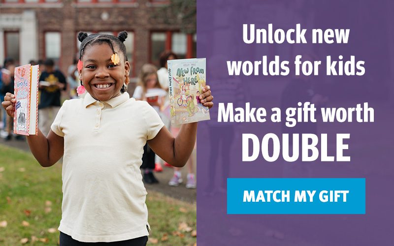 A graphic with a photo of an image of a student holding two books up and smiling to the left, and the text, Unlock new worlds for kids. Make a gift worth double, with a call to action button, match my gift, to the right.