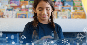 image of a girl reading a book and smiling. On the bottom border is white snow flakes with a blue background.