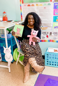 image of an educator in a classroom, holding a Mo Willems book and a Piggie stuffie.