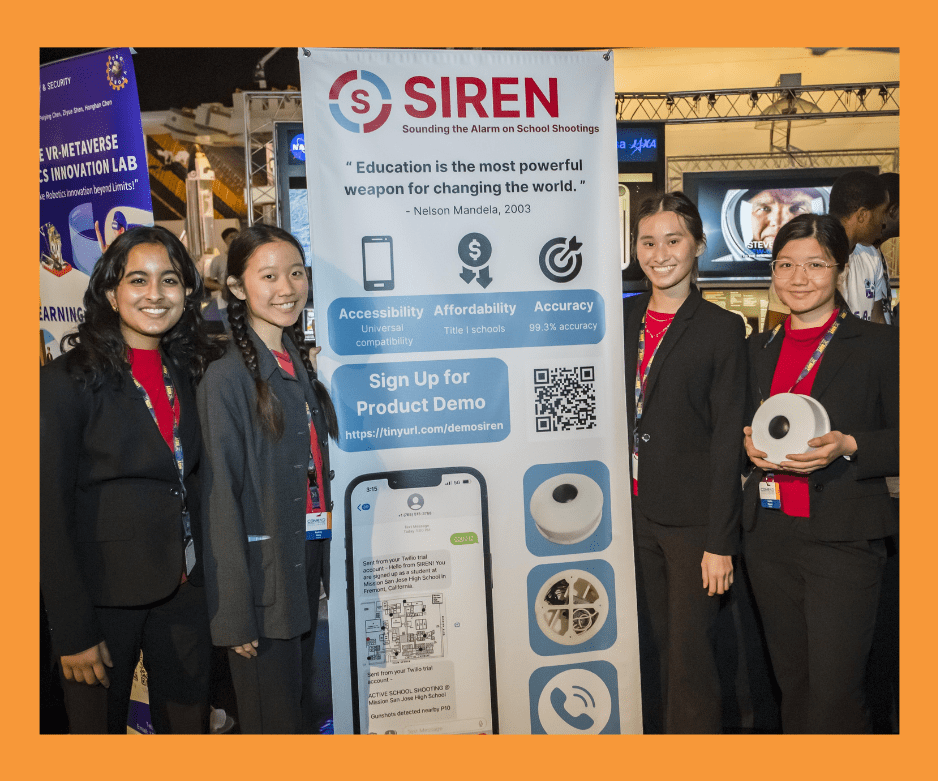 image of four girls standing next to a pop up sign about SIREN, a patent-pending gunshot detector and communicator designed to provide real-time alerts to students, faculty, parents, and law enforcement, cutting down the time it takes to alert law enforcement from 5 minutes to 5 seconds and vastly improving the accuracy of that communication.
