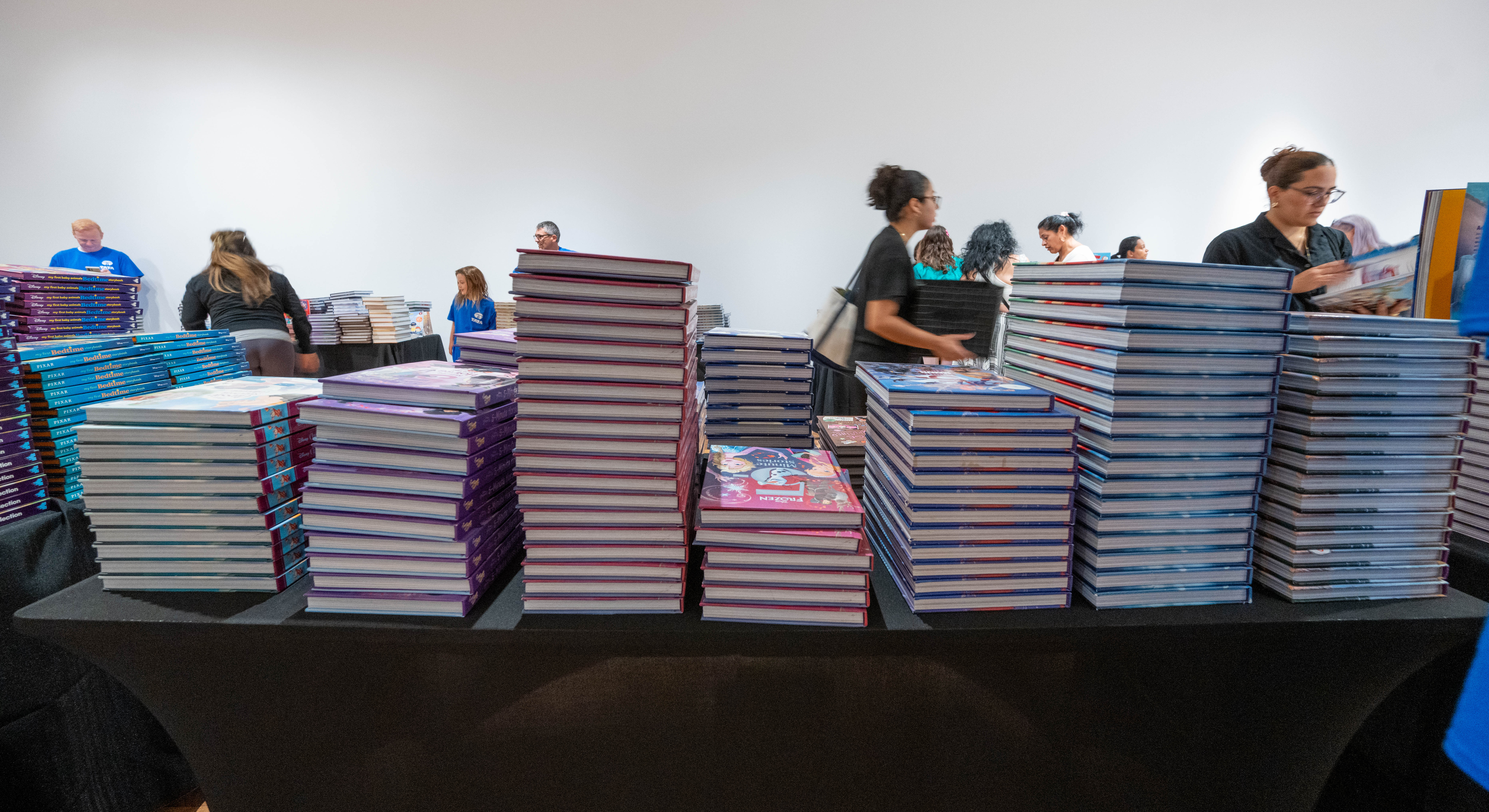 image of a table of books, neatly stacked.